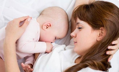 Mãe e bebê dormindo na cama