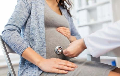 Médico exminando grávida